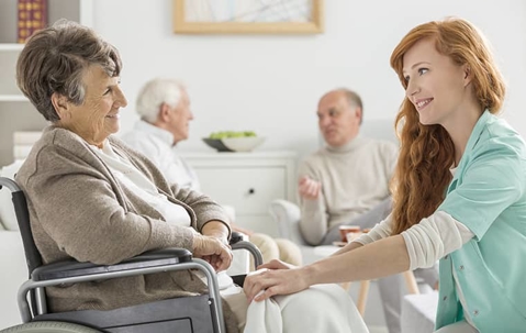 assisted living therapist speaking with a patient